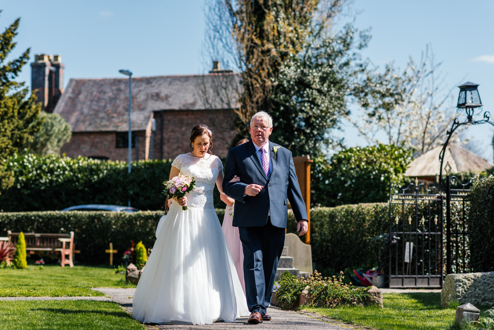 Bride and father walking to church