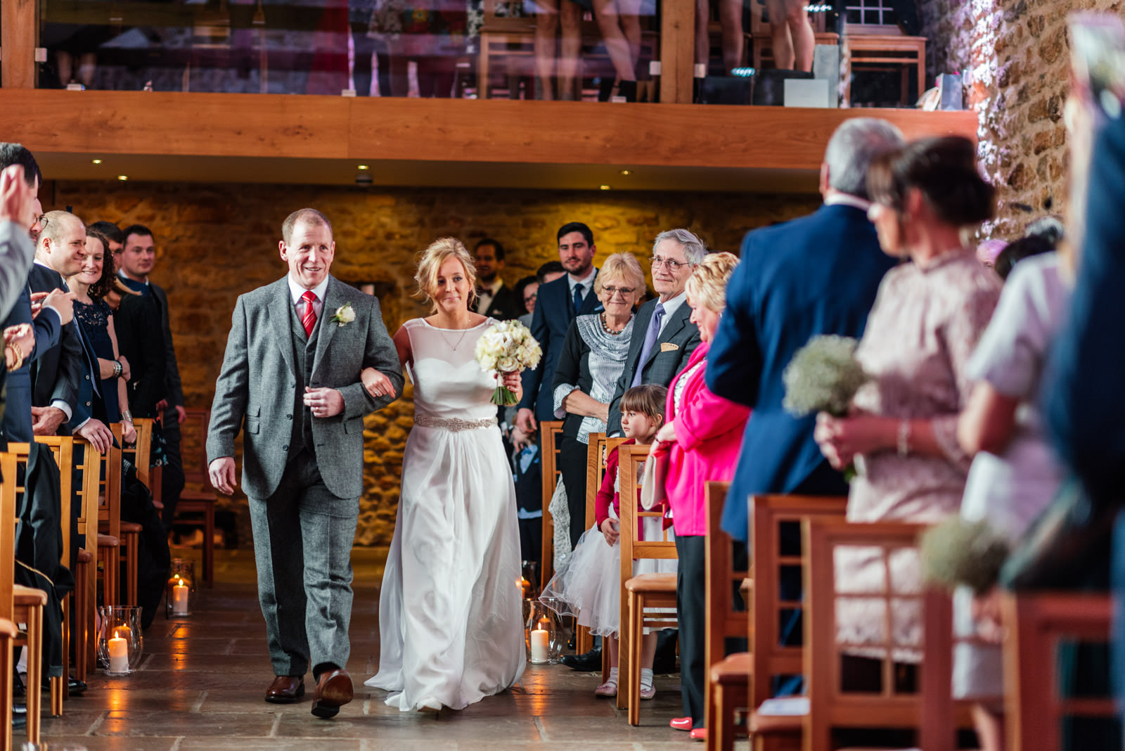 Bride walking down aisle in ceremony