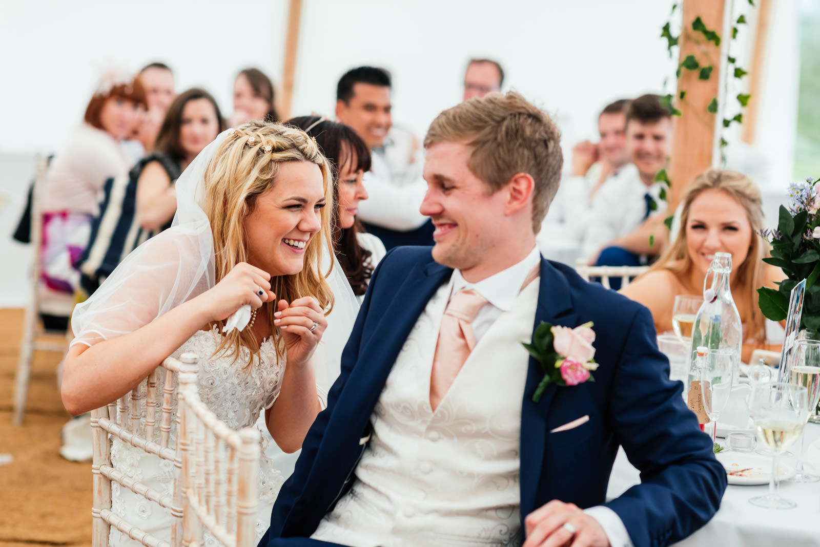 bride laughing at wedding speeches