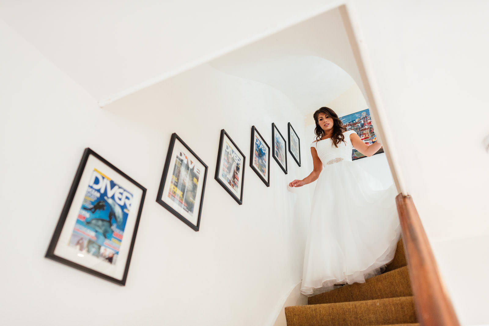 bride in dress walking down stairs