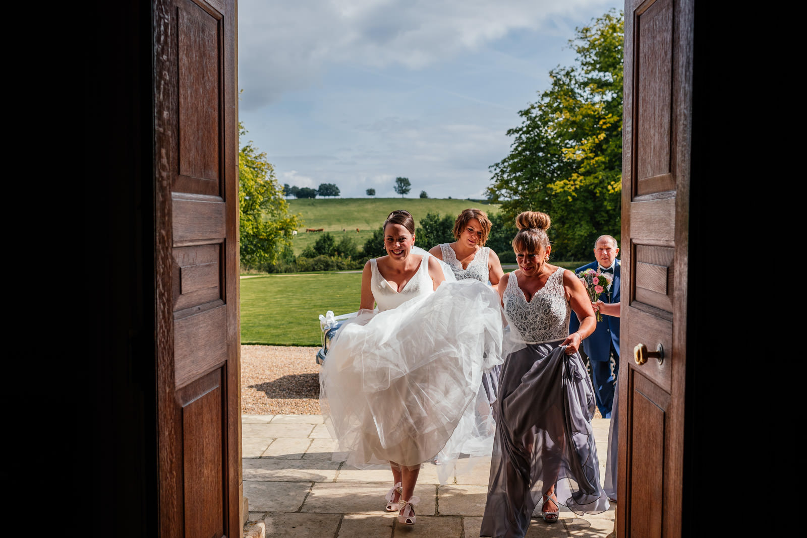 bride and bridesmaids walking in to the hall