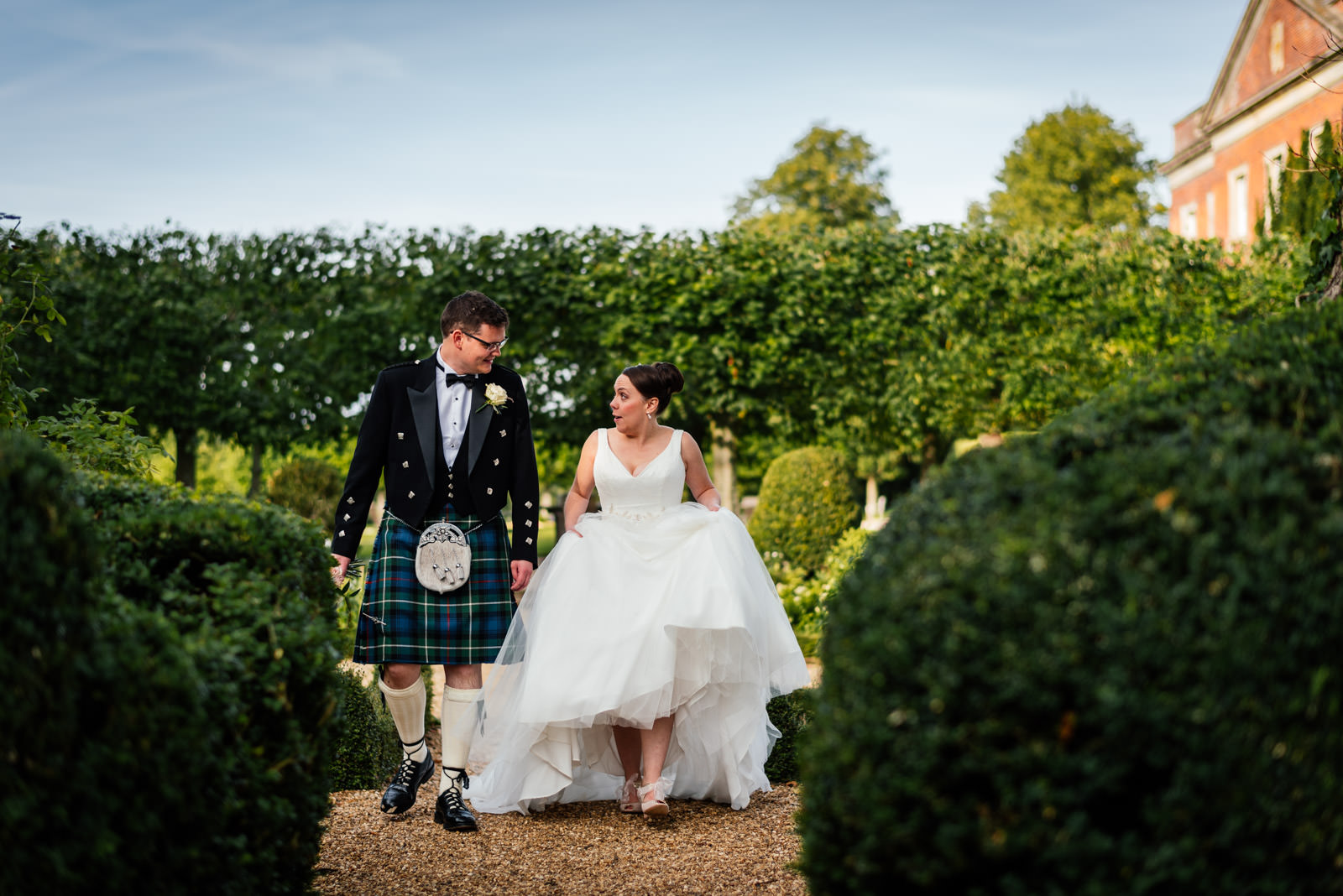 bride and groom walking through the garden