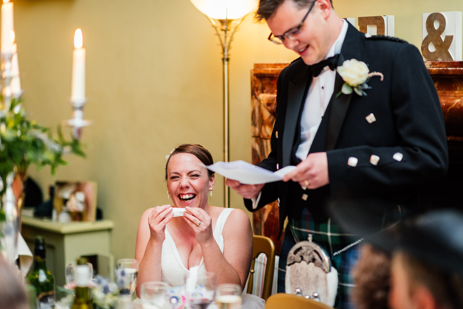 bride laughing at grooms speech