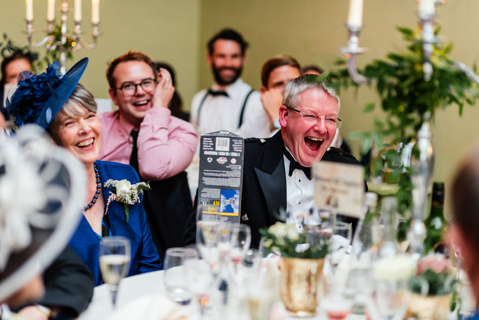 grooms parents laughing at grooms speech