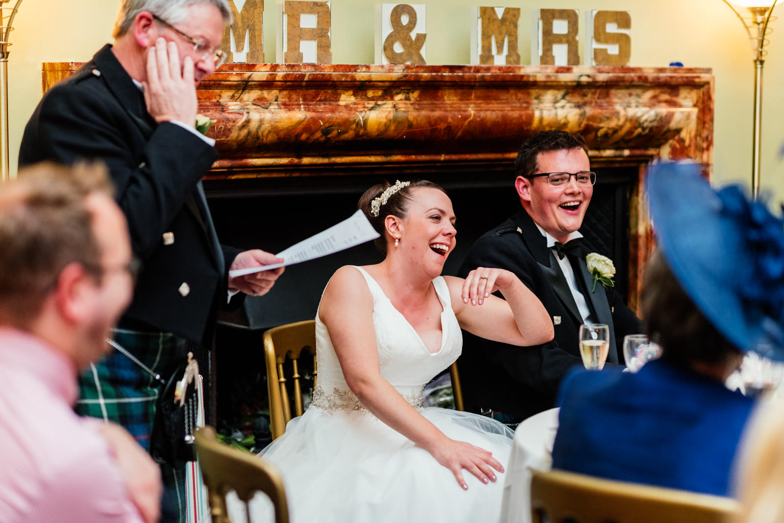 best man giving speech with guests laughing