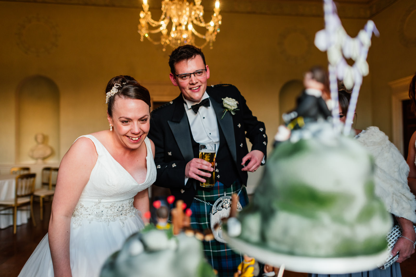 bride and groom looking at the wedding cake