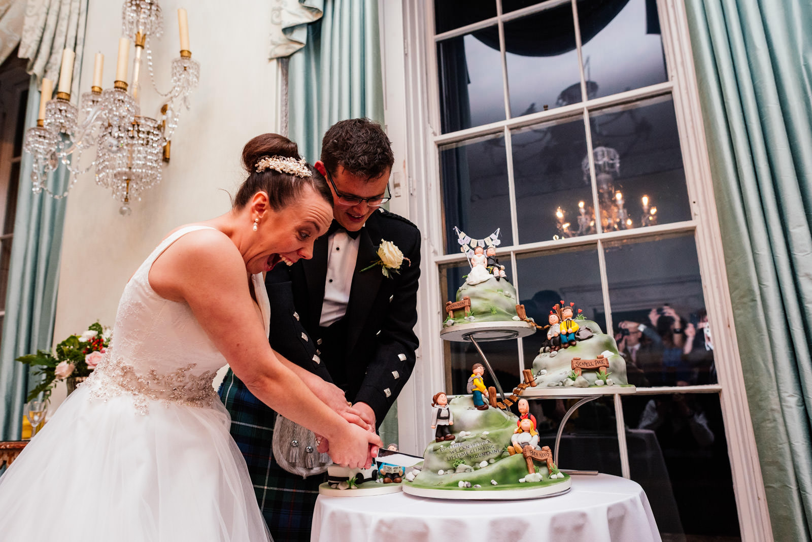 bride and groom cut the cake