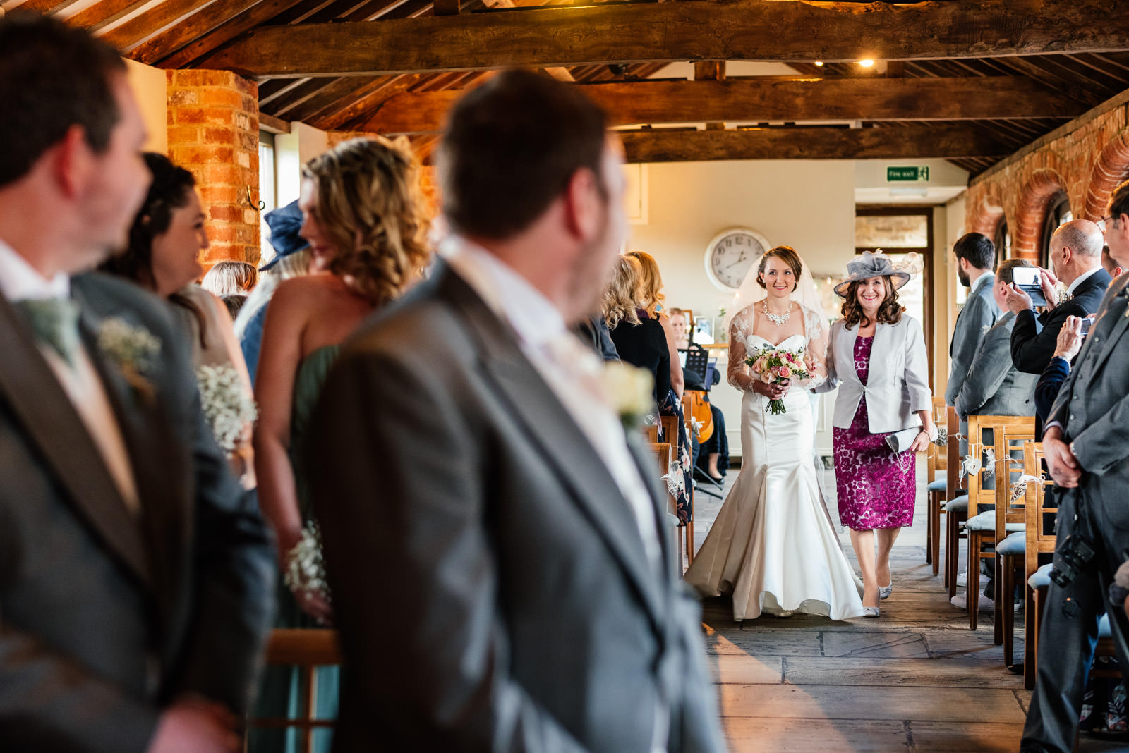 bride and mother of the bride walking the aisle