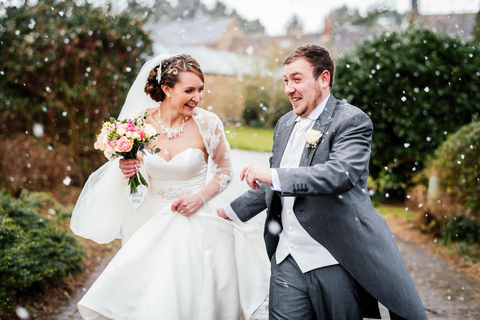 bride and groom walking through the snow