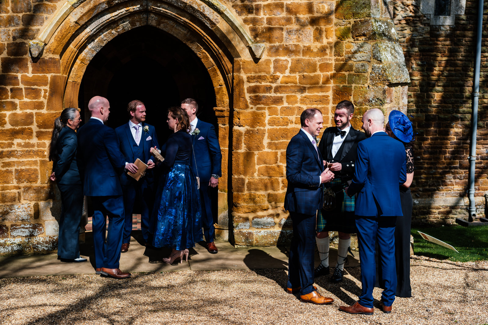 groom and grooms party waiting outside the church
