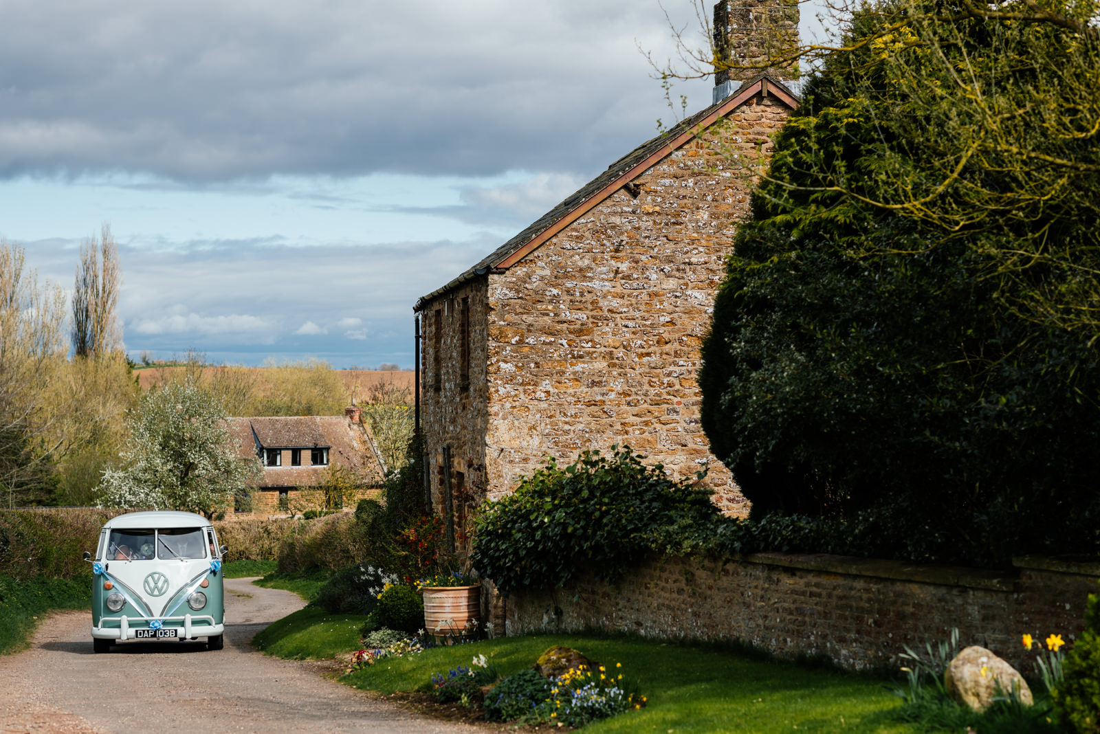 camper van arriving at church with bride and bridesmaids