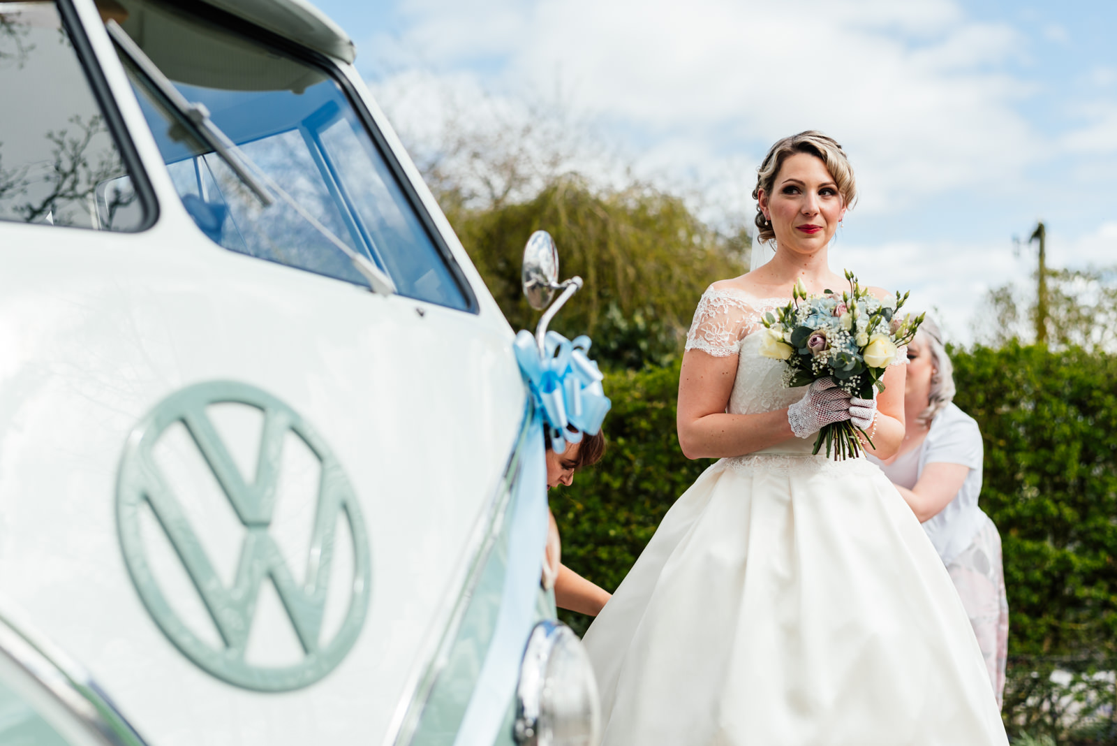 bride standing next to camper van just before walking to church