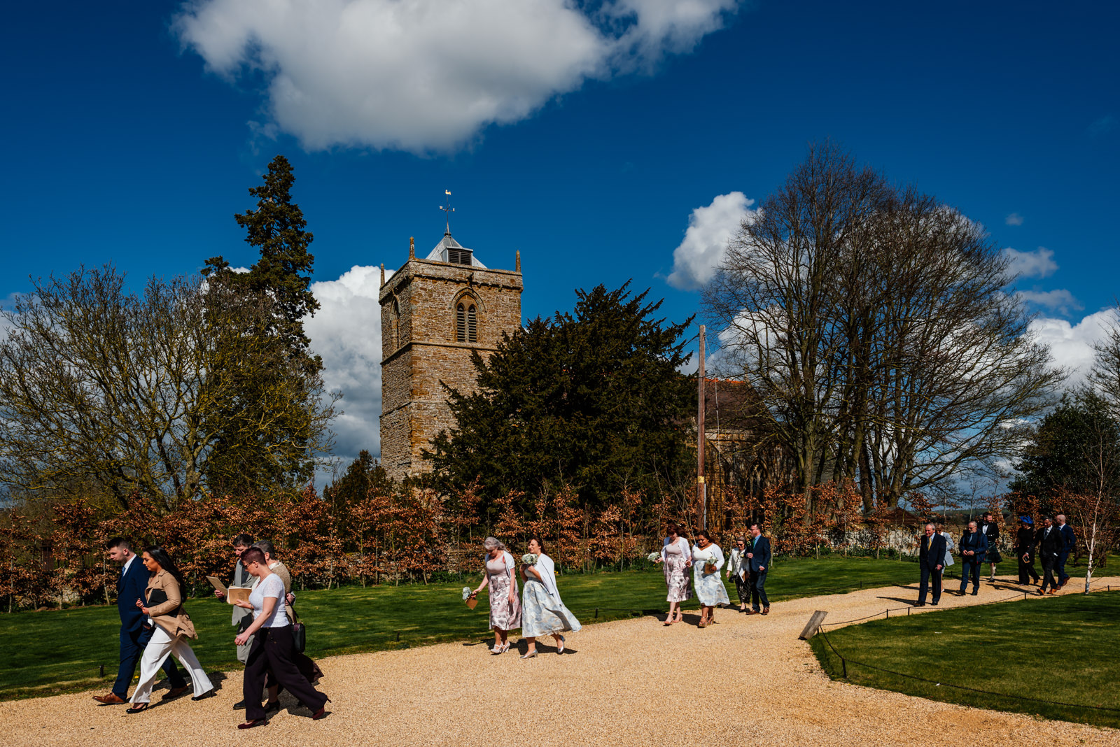 guests walking from church to Dodford Manor - blue sky