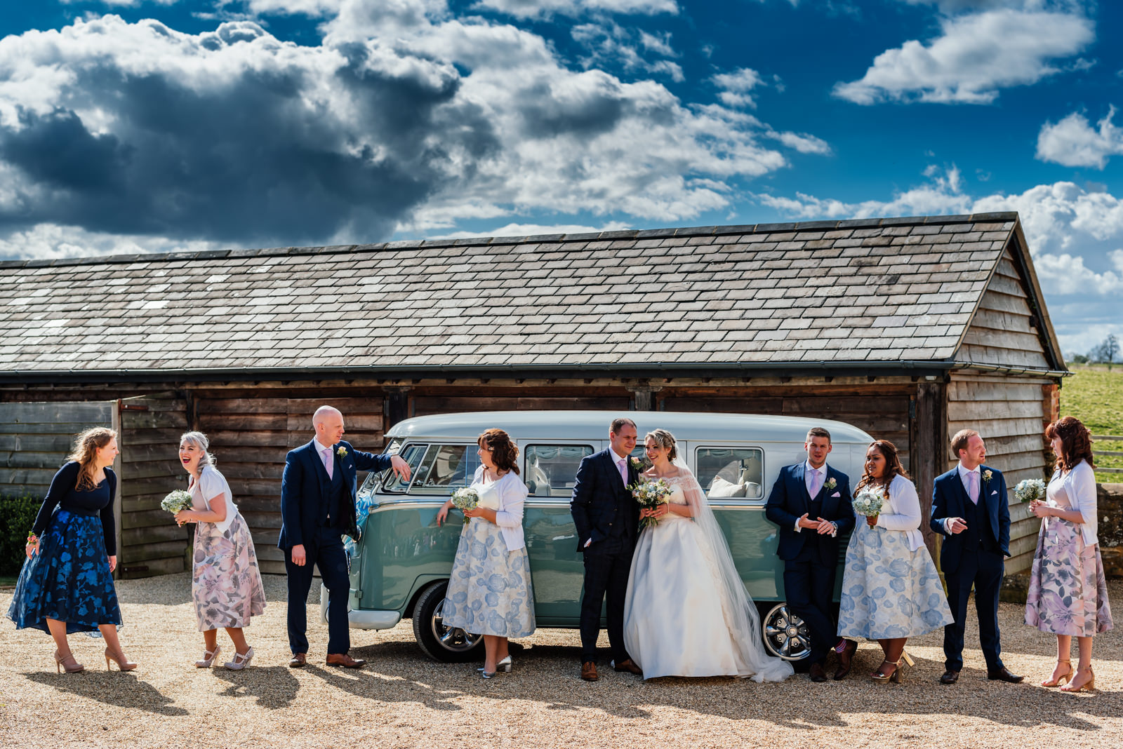 wedding party posing in front of campervan