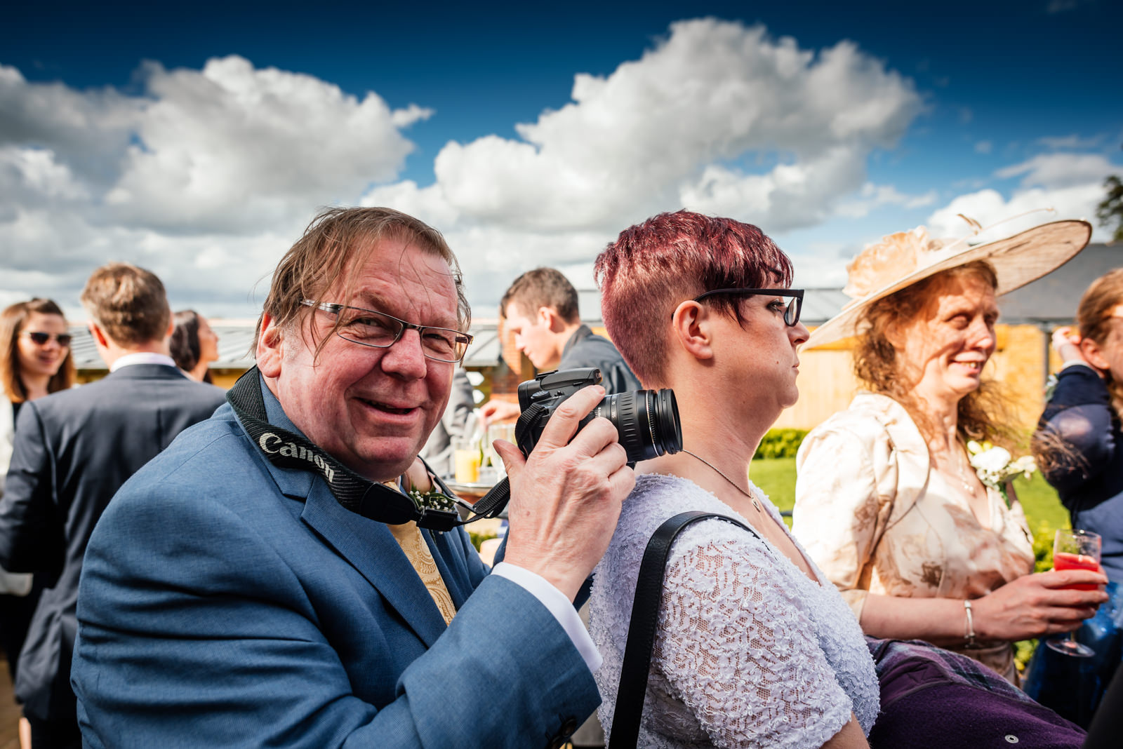 father of the groom taking photos