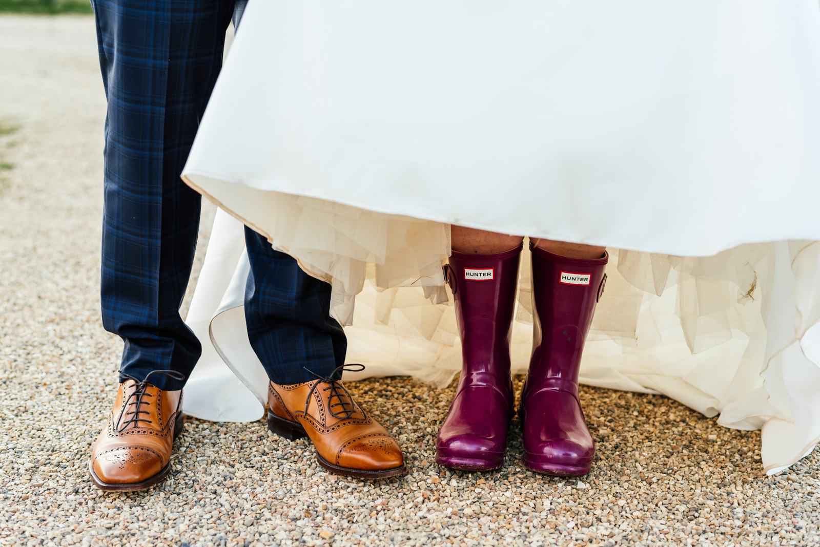 grooms shoes and bride wearing hunter welly boots