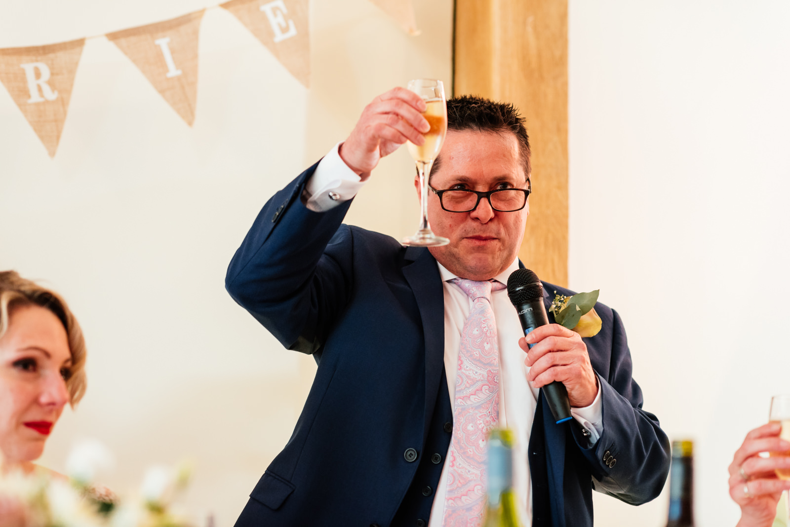 father of the bride raising his glass for a toast