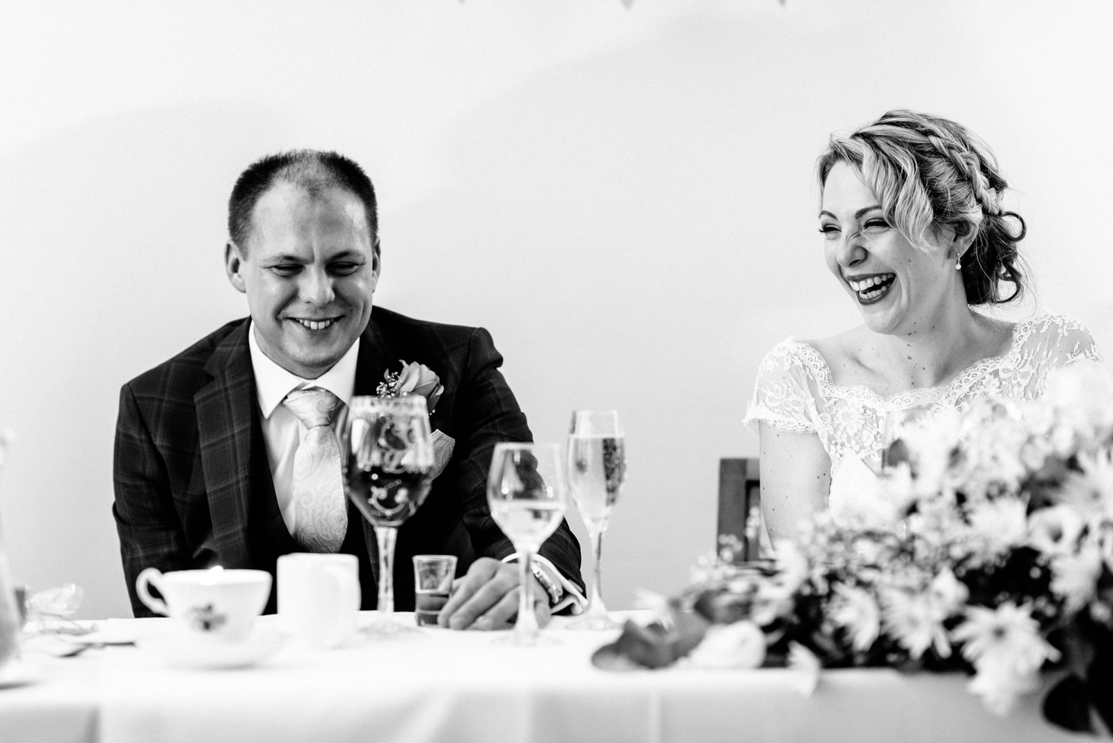 bride and groom listening to speeches