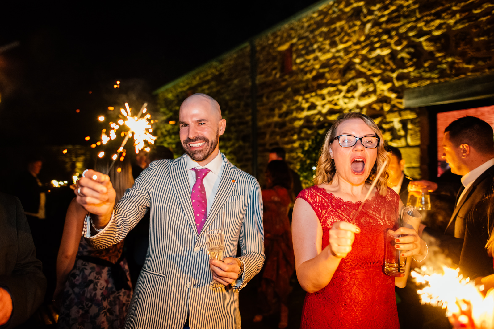 guests having fun with sparklers in the evening