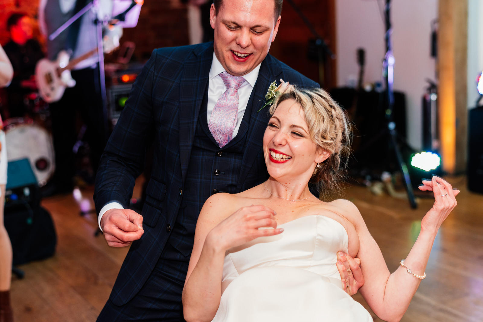 bride doing air guitar during first dance