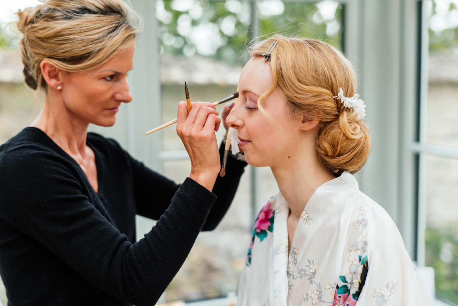 bride getting make-up in morning