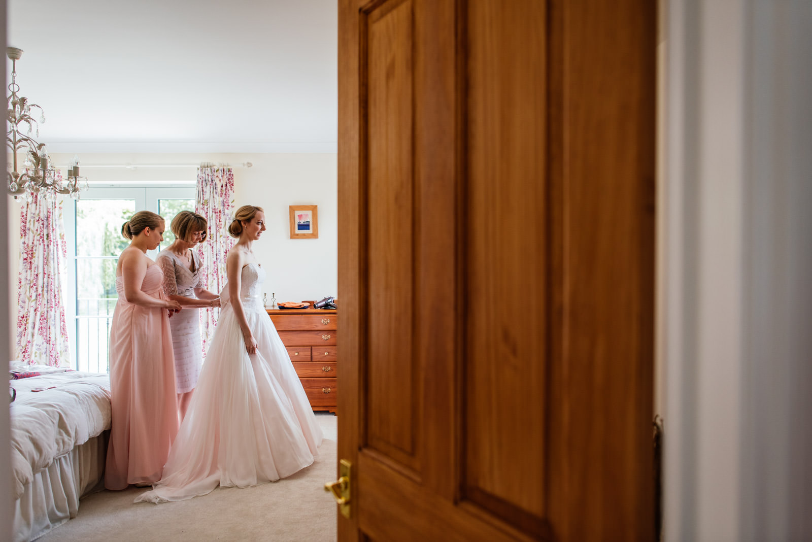 bride getting in to her wedding dress