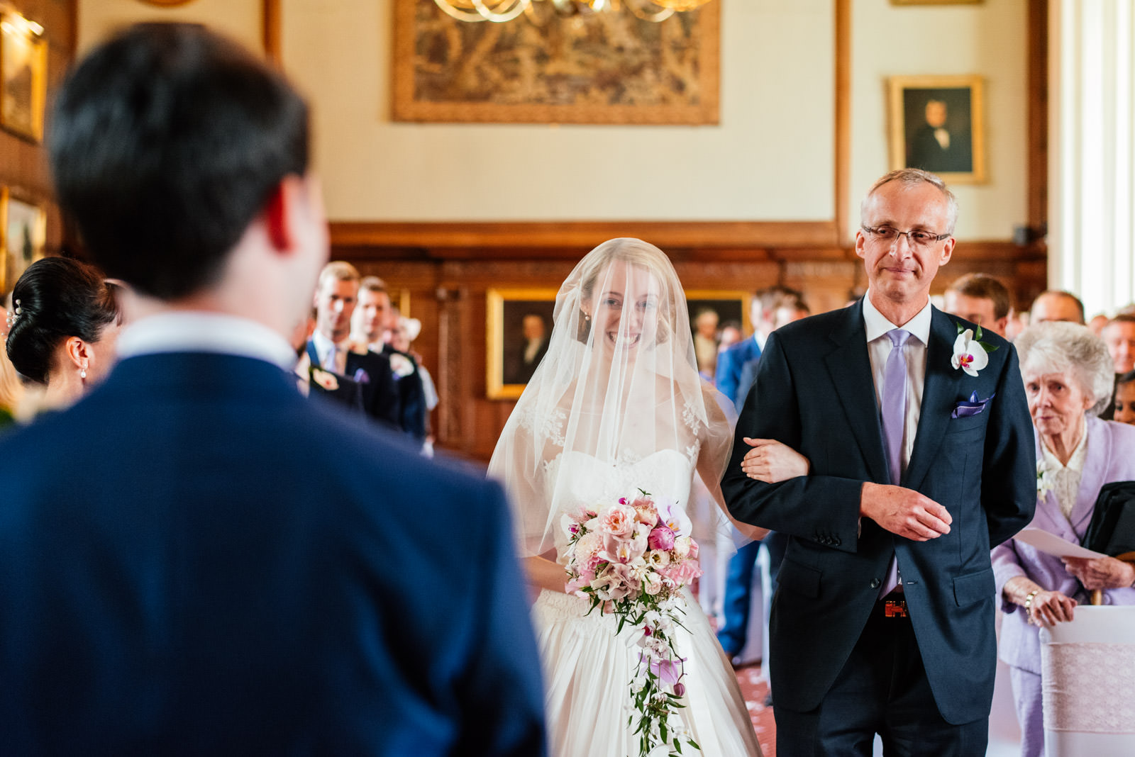 bride walking in to ceremony with father