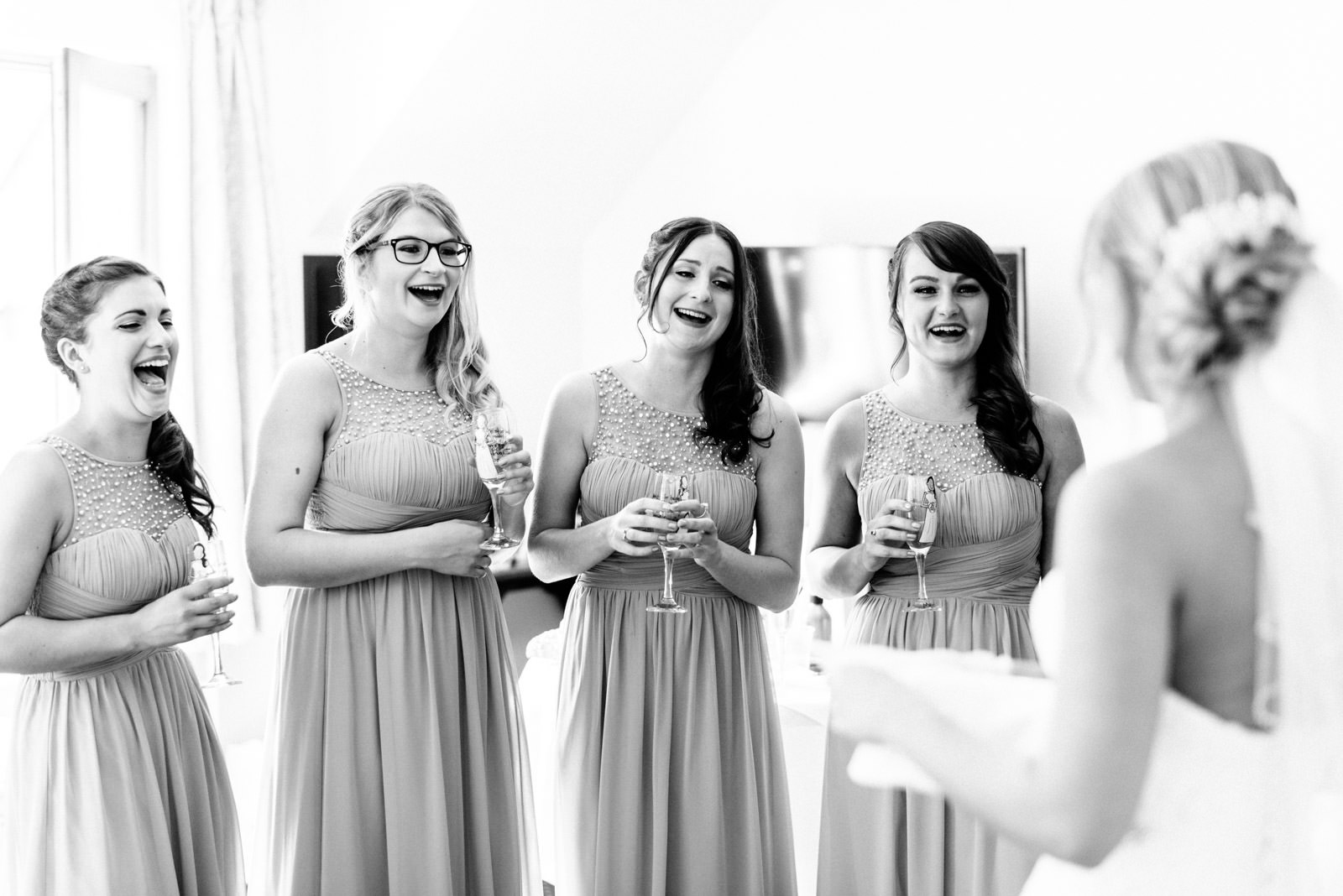bridesmaids laughing with bride