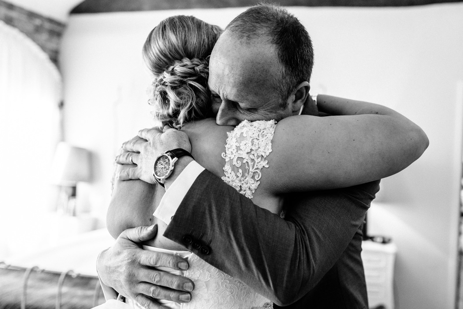 Father hugs his daughter on her wedding day