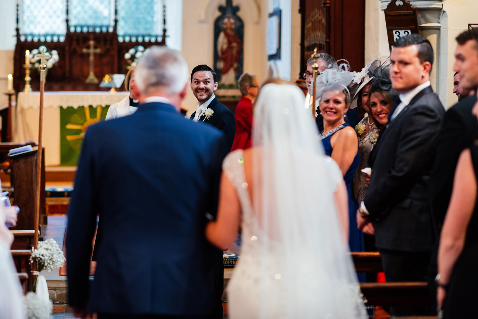 first look from groom as his bride walks down the aisle