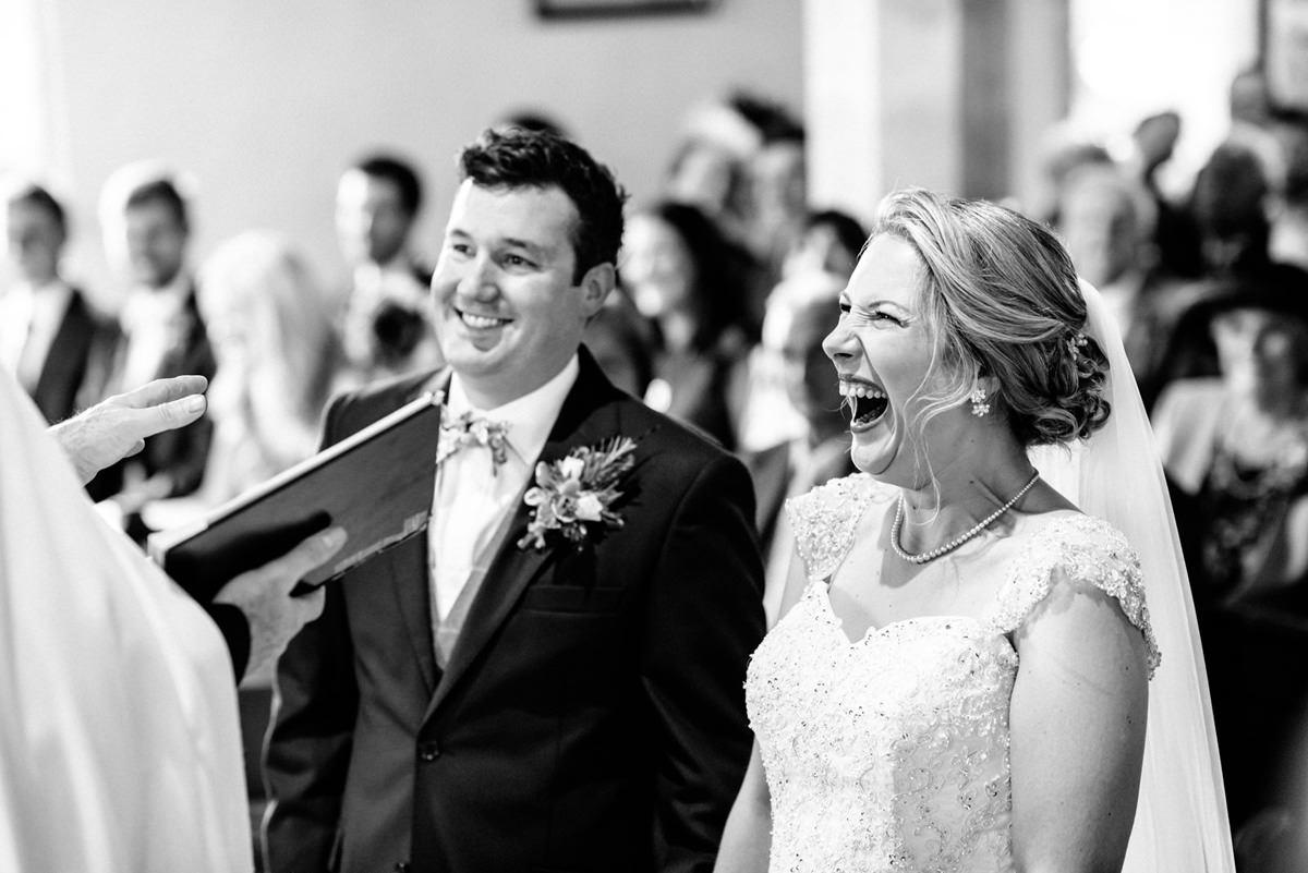 bride and groom laughing during ceremony