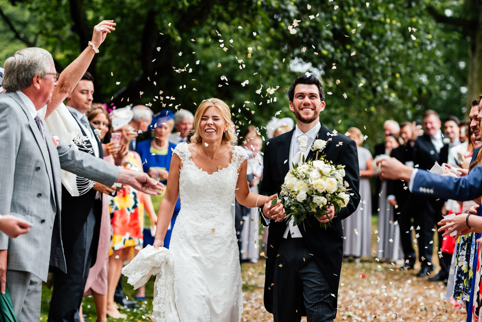 bride and groom walking through confetti