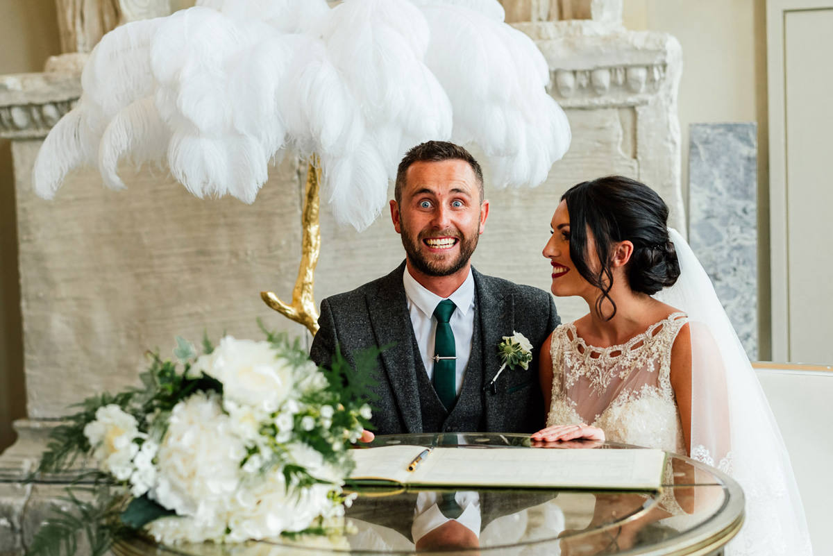 cheesy smile from a happy groom just after getting married