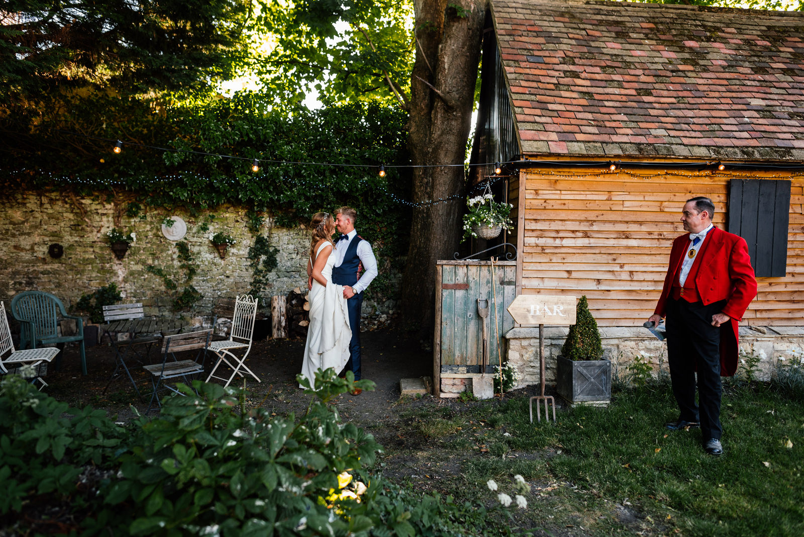 Bride & Groom having some time to themselves whilst being watched by the toastmaster