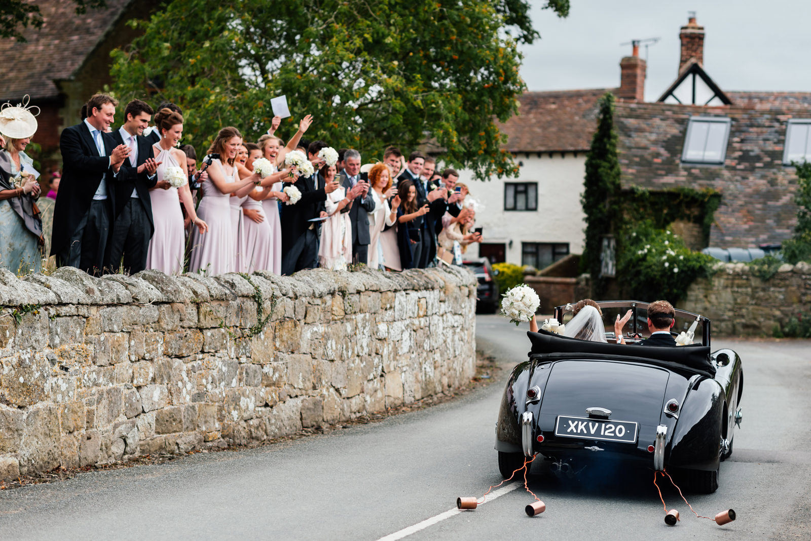vintage wedding car driven by the groom