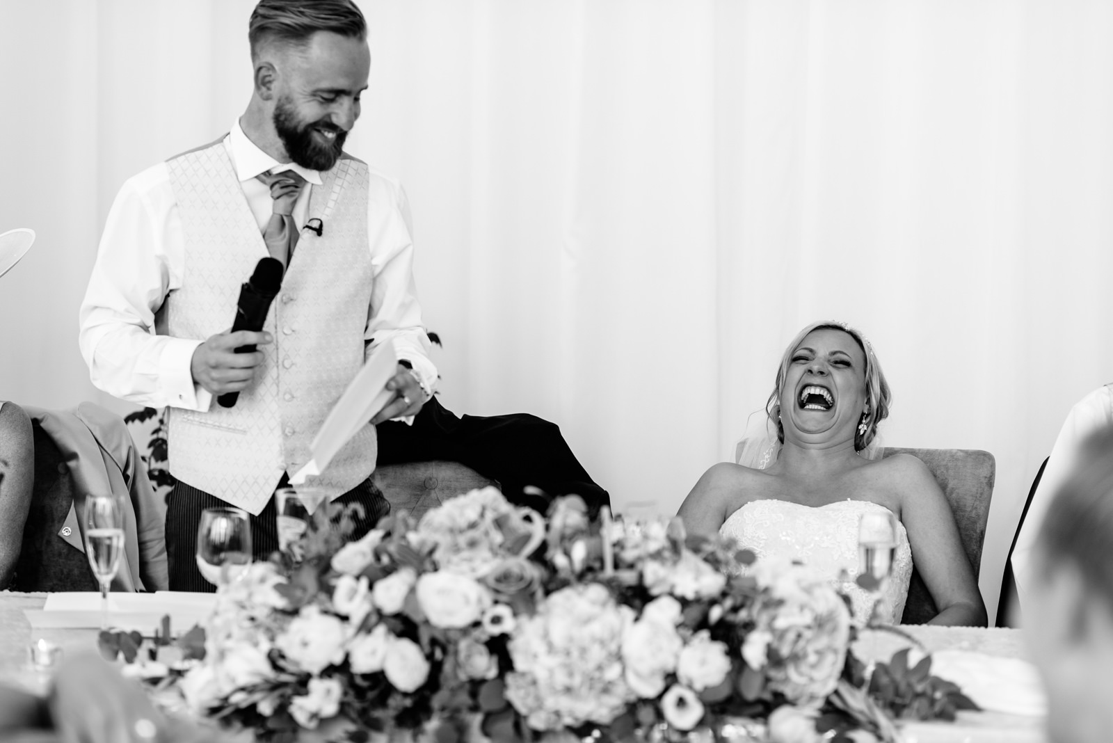 bride laughing at groom's speech