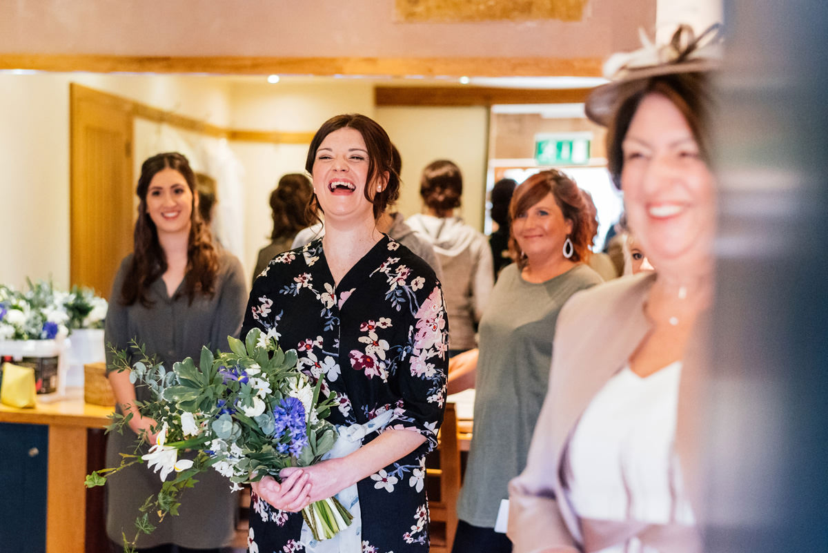 bride laughing with bouquet