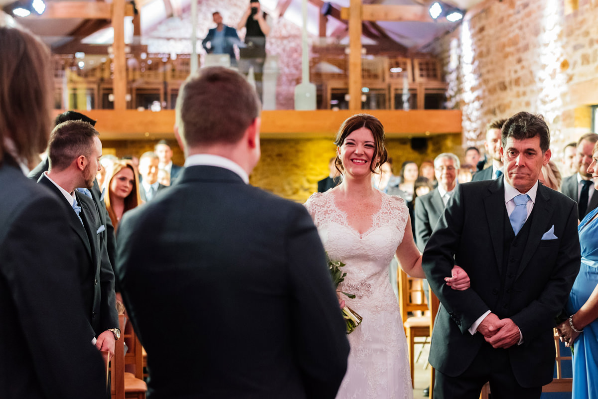 bride and father of the bride walking down the aisle