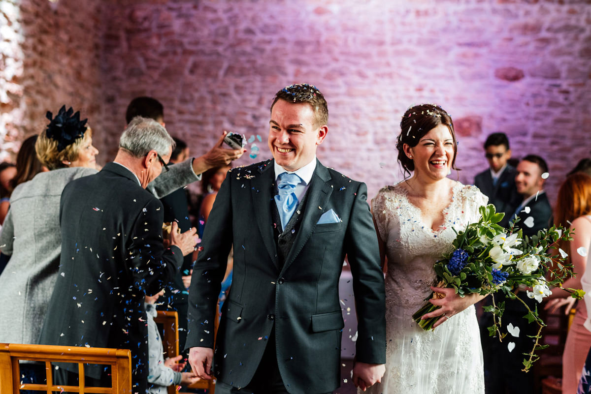 confetti as bride and groom leave the ceremony