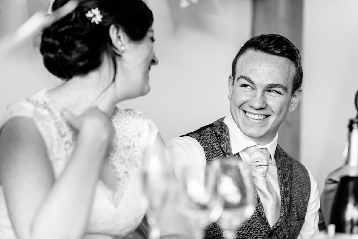 groom smiling during speeches