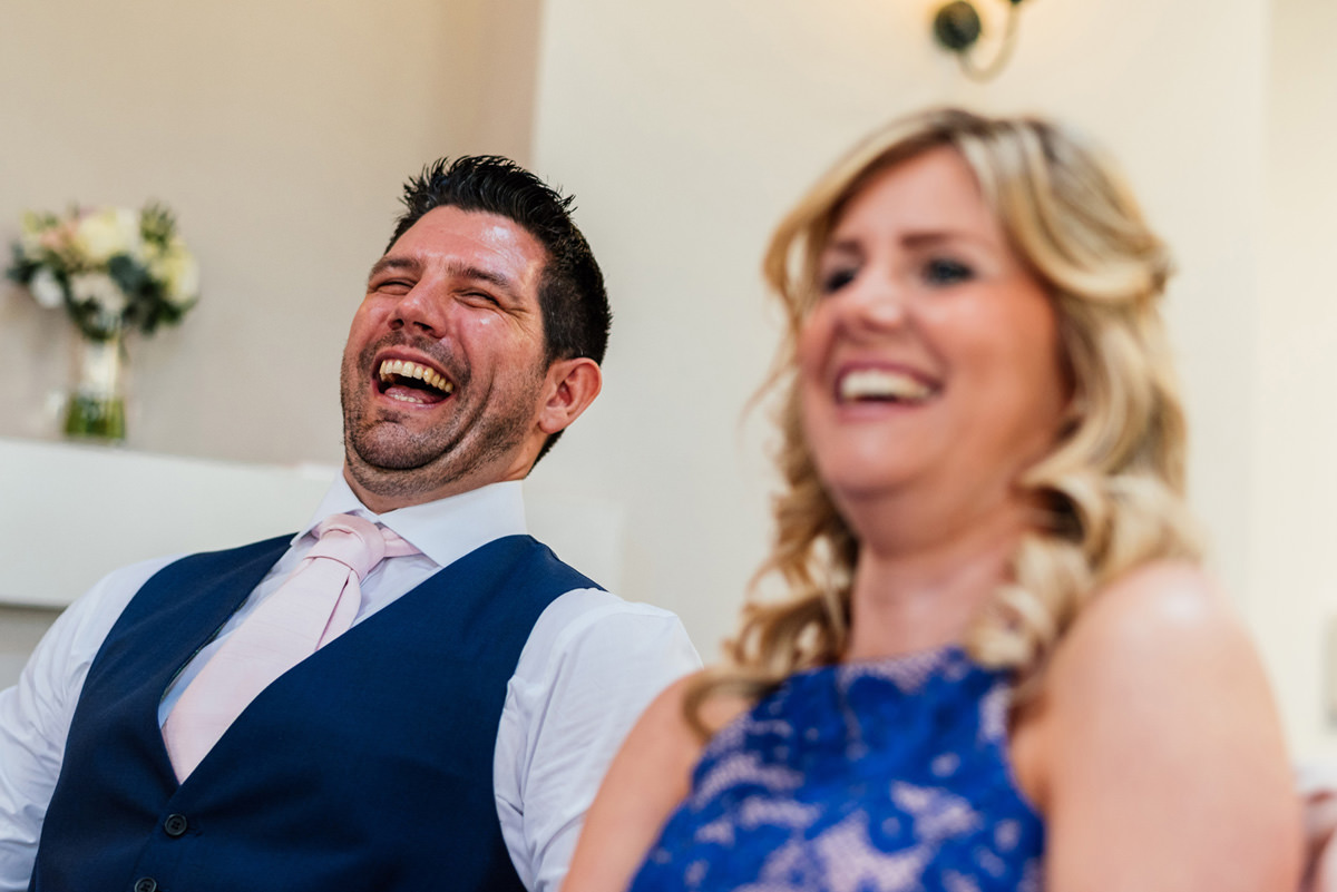 guest laughing at wedding speeches