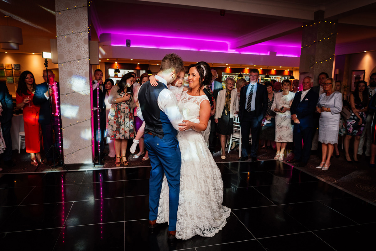 bride and groom first dance with their daughter