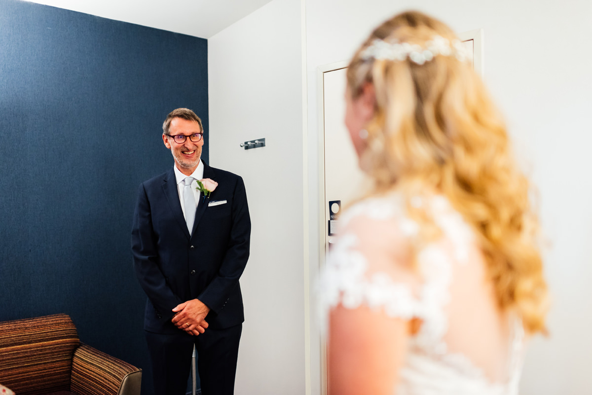 father of the bride seeing his daughter for the first time in her wedding dress