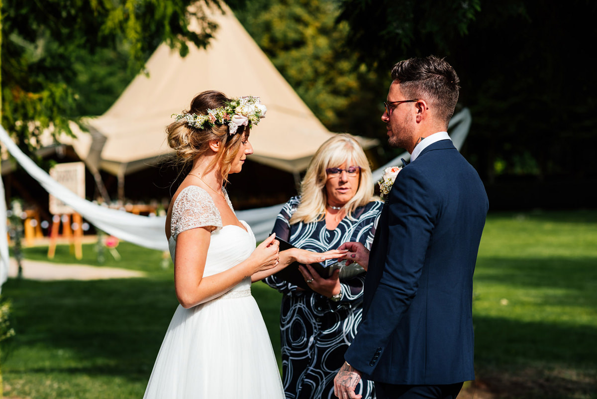 exchanging vows during outdoor ceremony