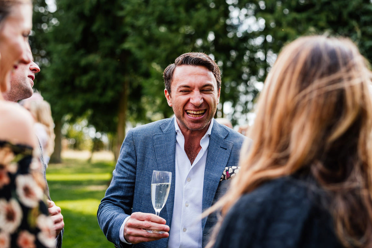 guest laughing during drinks reception