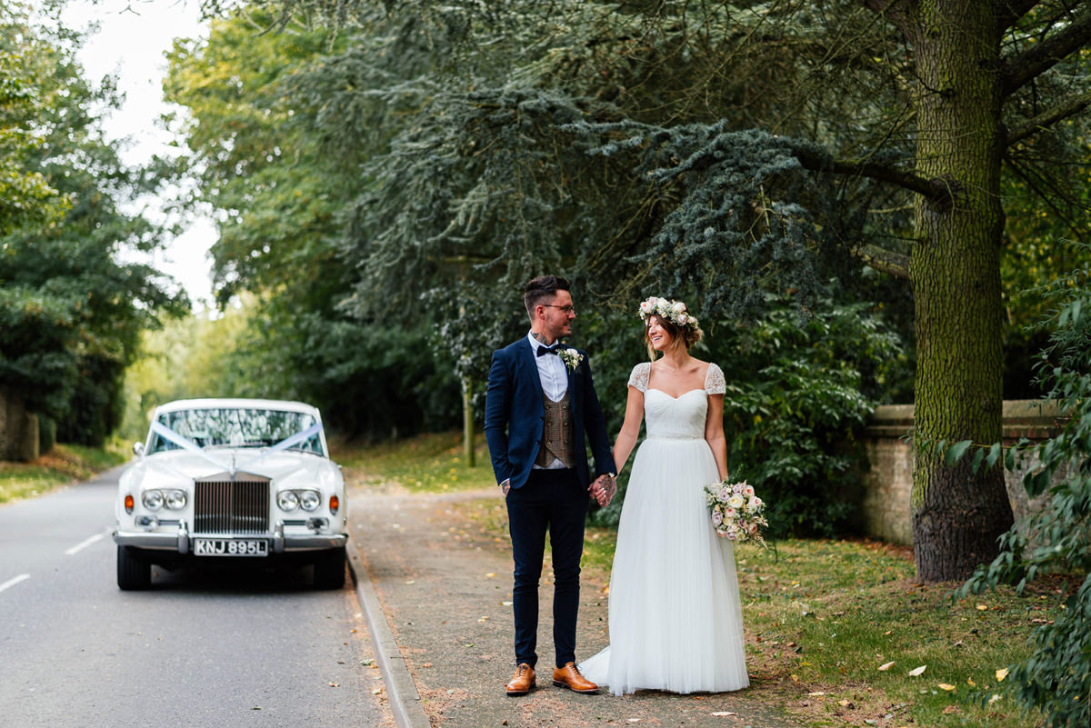 bride and groom with wedding car