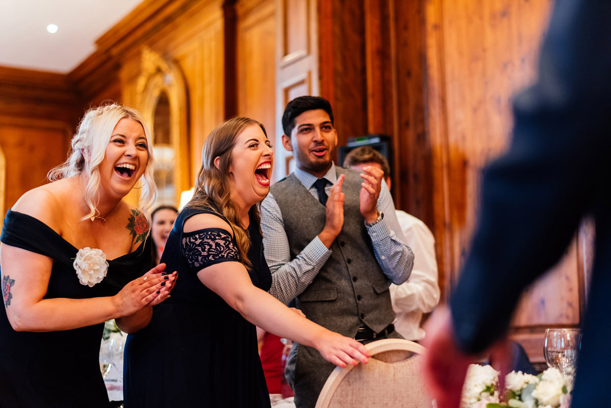 guests laughing during the wedding speeches