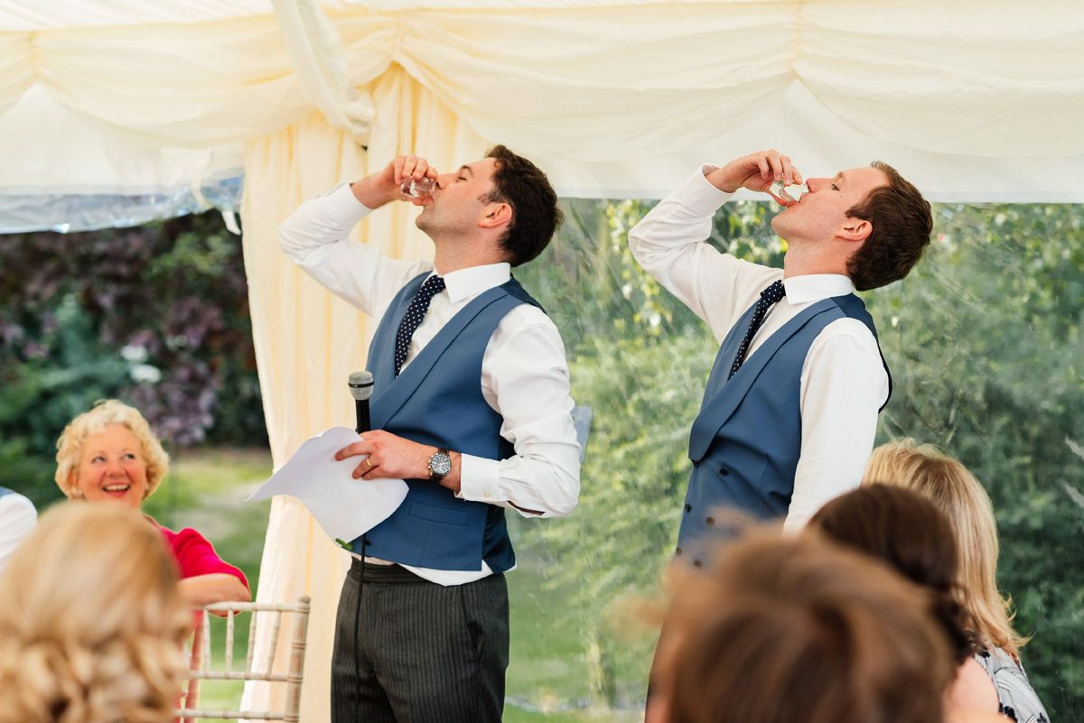 best men drinking shots during the speeches