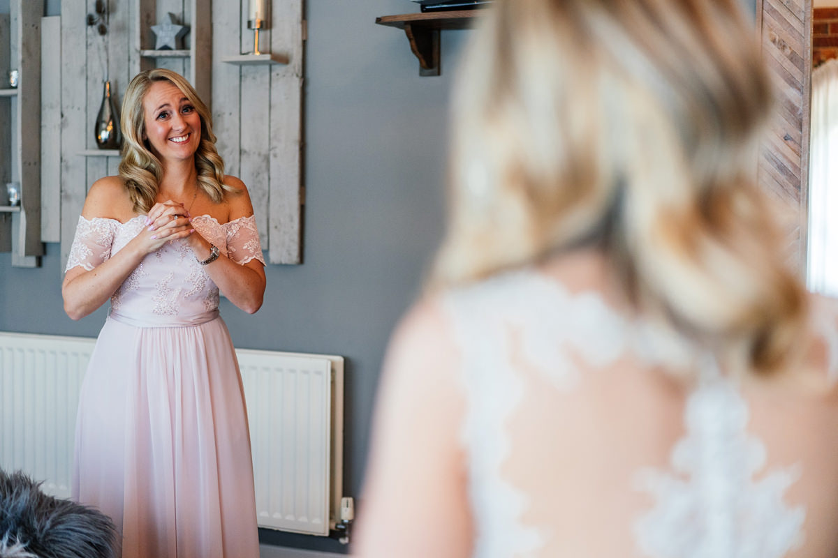 maid of honour sees bride for the first time in her dress