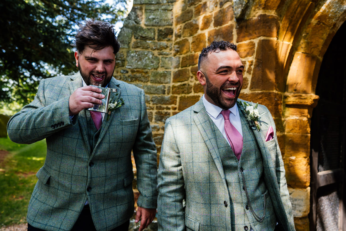 Groom and best man have a drink before the church ceremony